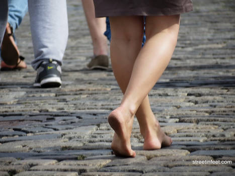 barefoot girl walks with dirty feet