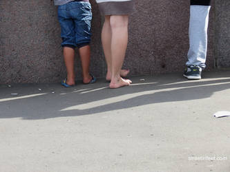 barefoot girl walks with dirty feet