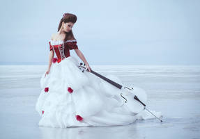 Beautiful brunette in a dress with cello