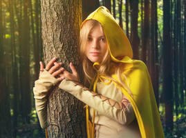 Blond girl dressed in dress walk in a magic forest