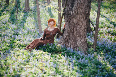 Beautiful young woman in the forest with flowers