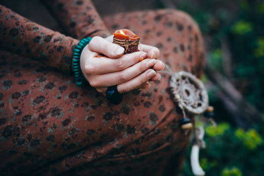 Beautiful young woman in the forest with flowers