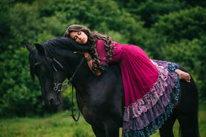Beautiful gypsy in violet dress with horses