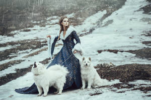 The woman in blue coat walk with a dog