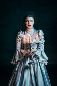 Woman in victorian dress imprisoned in a dungeon