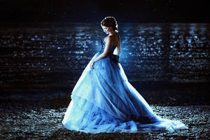 Beautiful lady in blue dress walking near sea