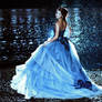 Beautiful lady in blue dress walking near sea
