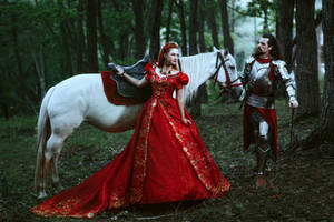 Medieval knight with his beloved lady in red dress