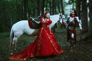 Medieval knight with his beloved lady in red dress