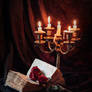 Book with antique candlestick and flowers