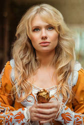 Beautiful lady with blond hairs in medieval dress