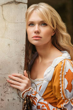 Beautiful lady with blond hairs in medieval dress