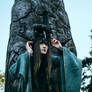 Woman-shaman with horns in  dress walk in forest