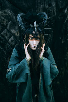 Woman-shaman with horns in dress walk in forest