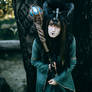 Woman-shaman with horns in  dress walk in forest