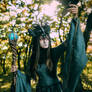 Woman-shaman with horns in  dress walk in forest