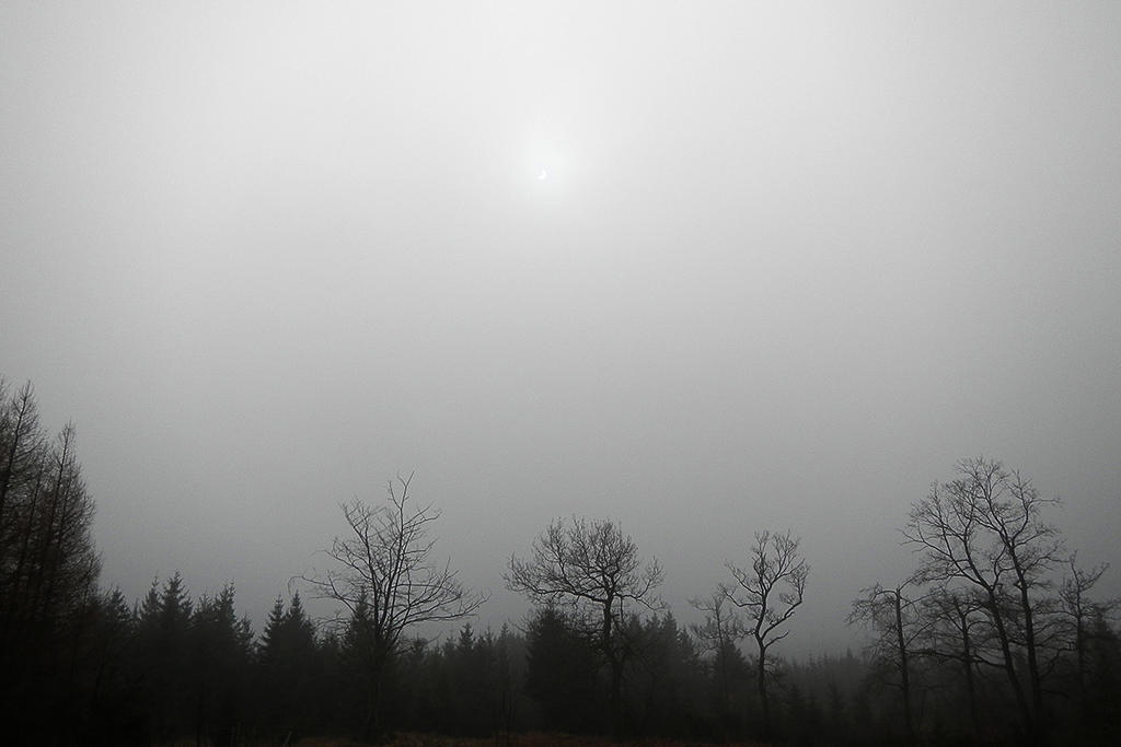 Solar eclipse behind fog