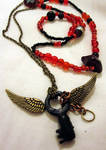 Red and black wings necklace by Gothic-Enchantress