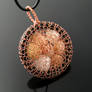 Wire knit pendant with caged shells