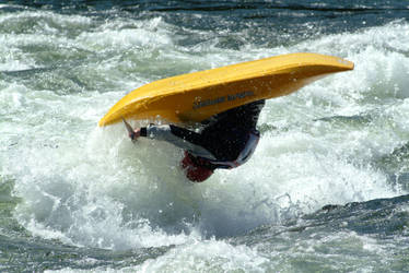 Yellow kayak in mid-air