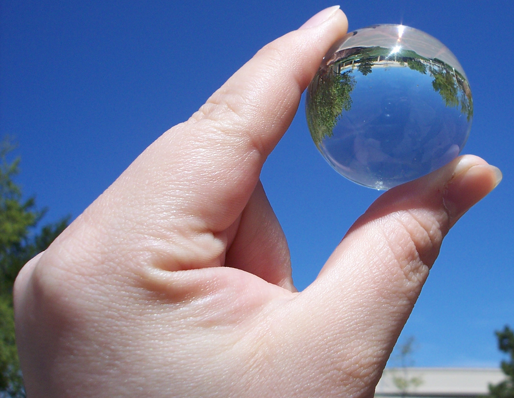 Hand holding glass ball