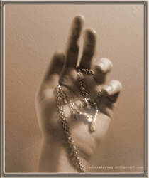 A hand and a necklace