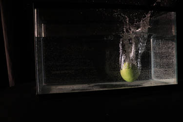 Apple being dropped into a water tank
