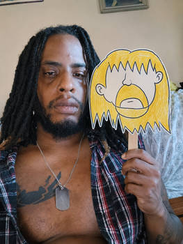 I'm holding die-cut cardboard mask of one of my oc