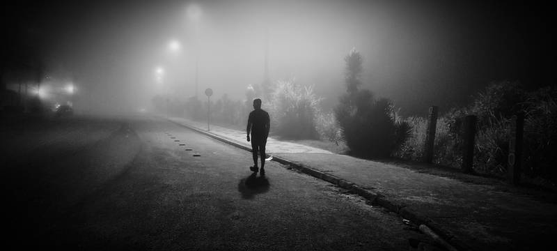 Lonely walk on a foggy night