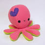 Pink octopus plush with purple heart