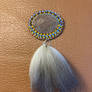 Beaded brooch with coyote fur