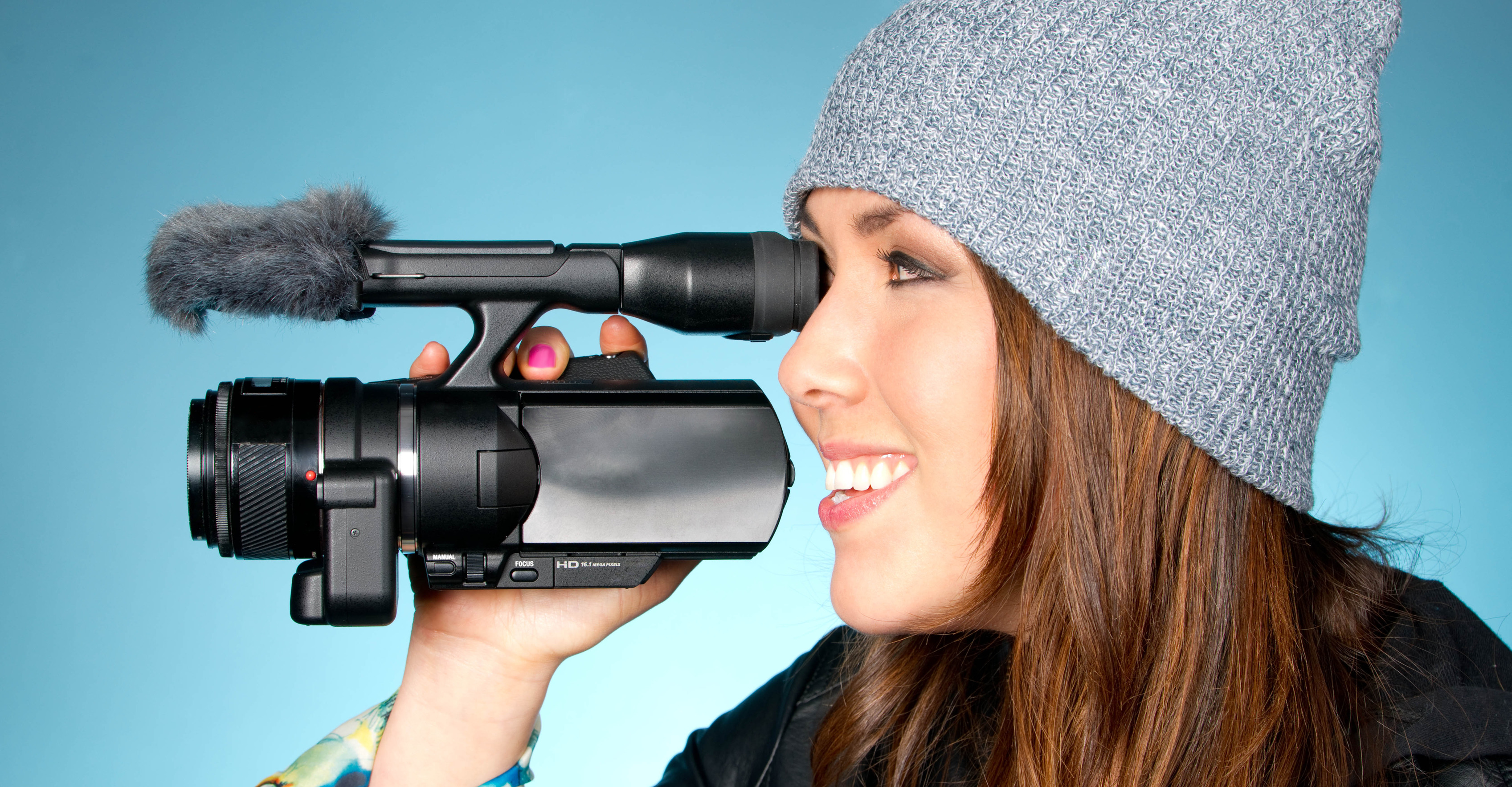 Young adult female points video camera