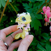 Pale yellow baby dragon with cherry blossoms