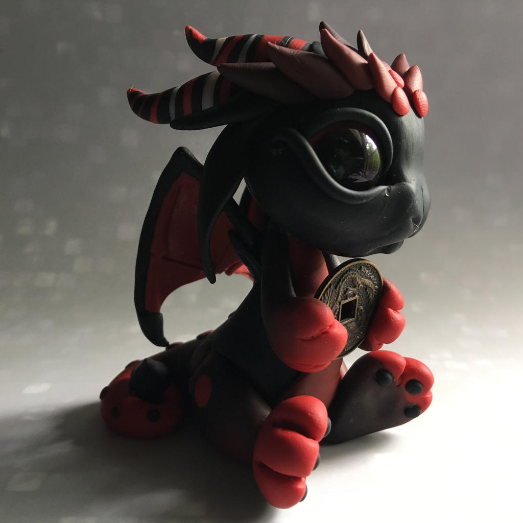 Black and red baby coin dragon. 