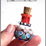 Red and blue miniature glass bottle