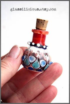 Red and blue miniature glass bottle