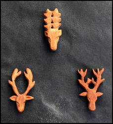 Stag head amulets