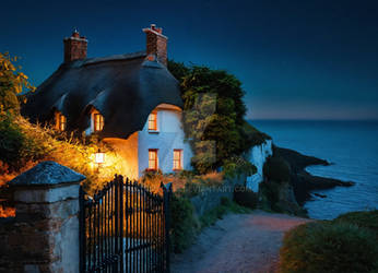 Beautiful thatched cottage at night