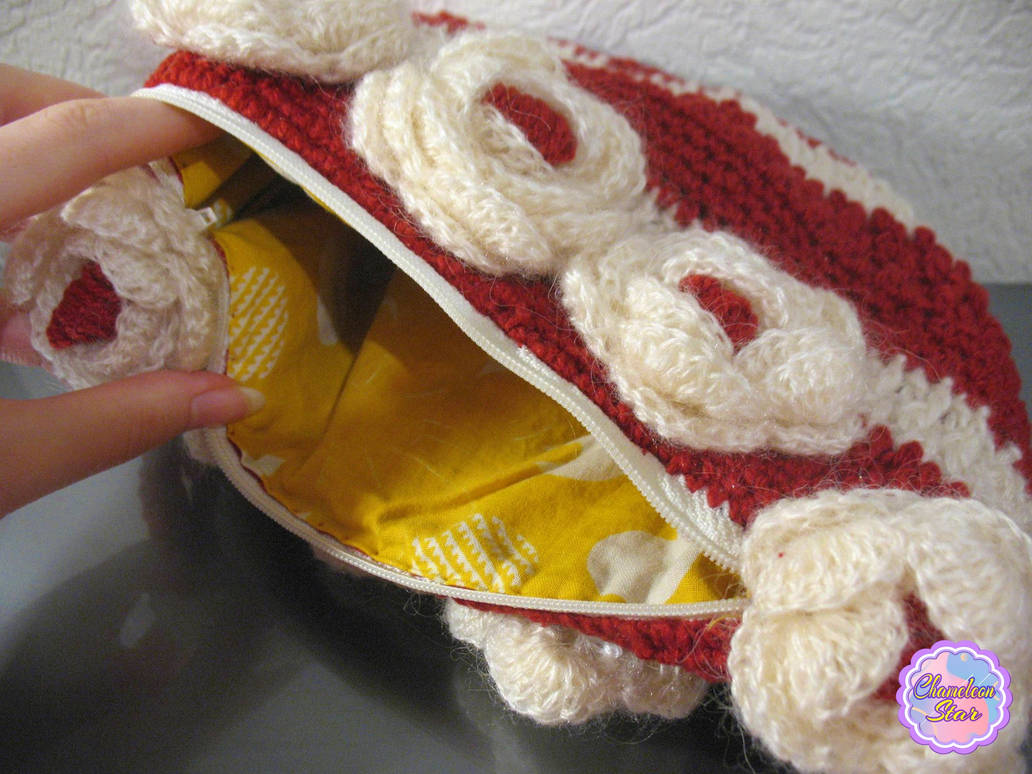 A WIP photo of handmade crochet milky-white zipper pouch called Imelda