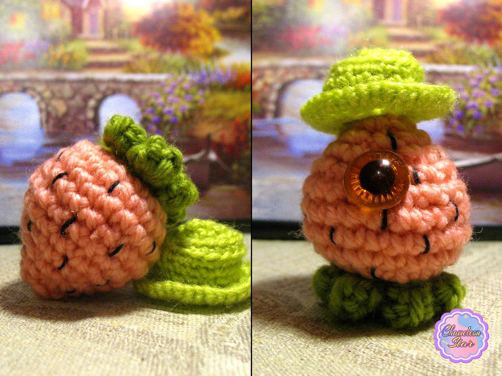 A photo of handmade crochet amigurumi pink Mr. Strawberry