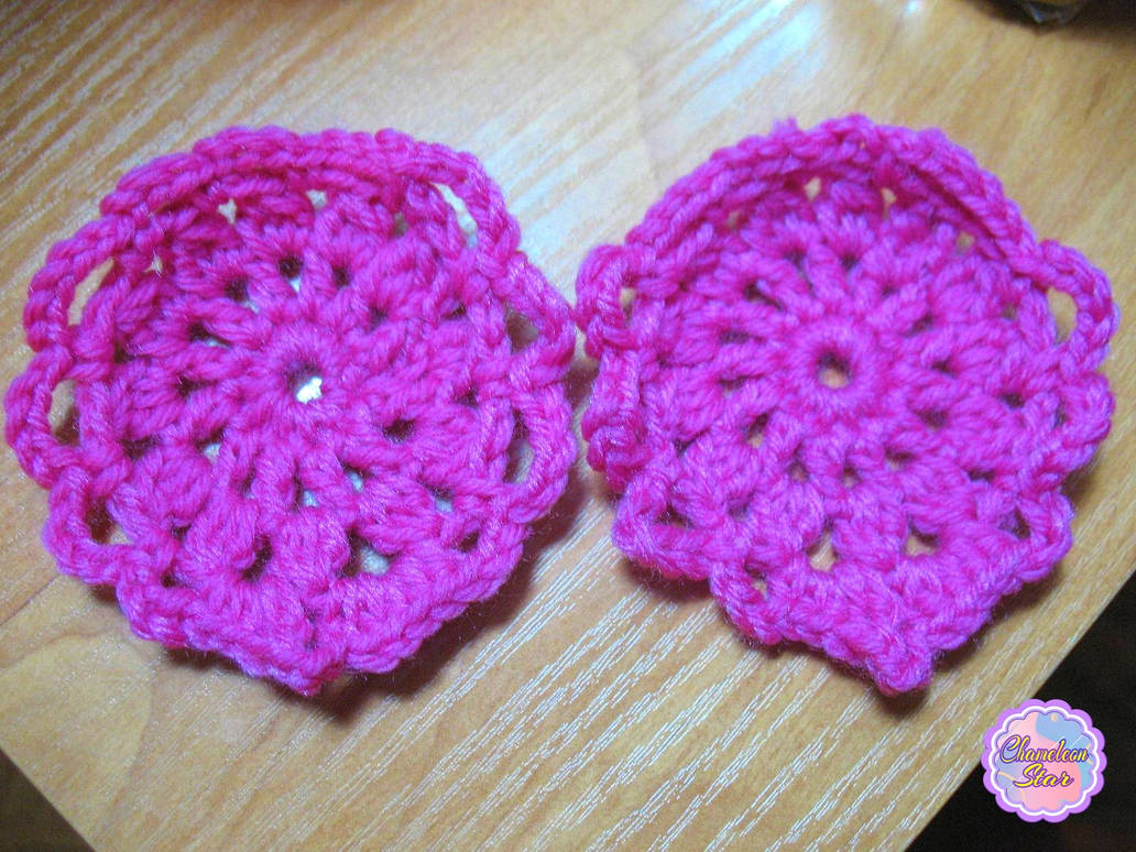 A photo of two handmade crochet magenta ornaments