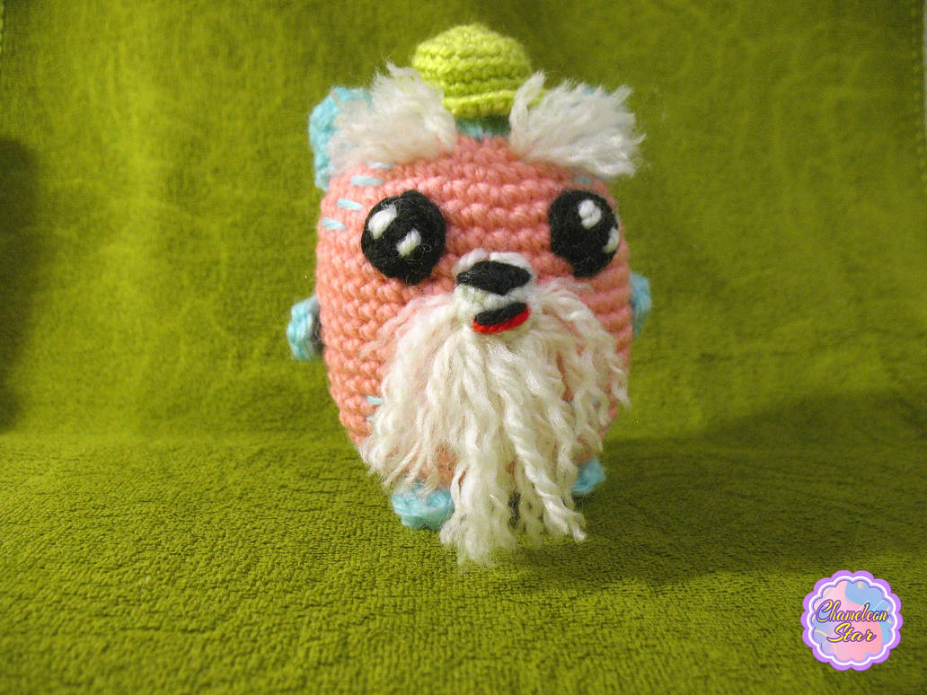 A photo of handmade crochet amigurumi pink cat called Donnagan, who are a part of a big Tororo Puss family