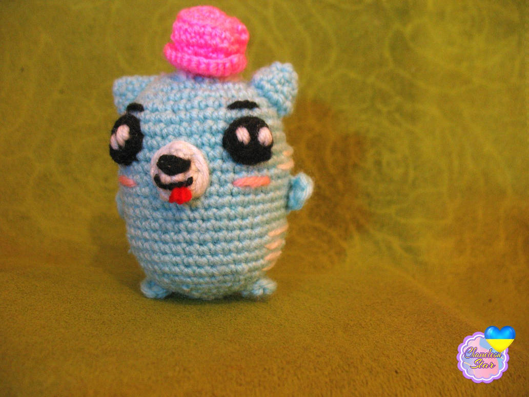 A photo of handmade crochet amigurumi turquoise cat named Arlen, who are a part of a big Tororo Puss family