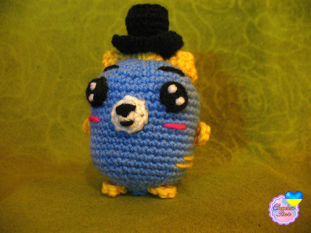 A photo of handmade crochet amigurumi blue cat named Quillan, who are a part of a big Tororo Puss family