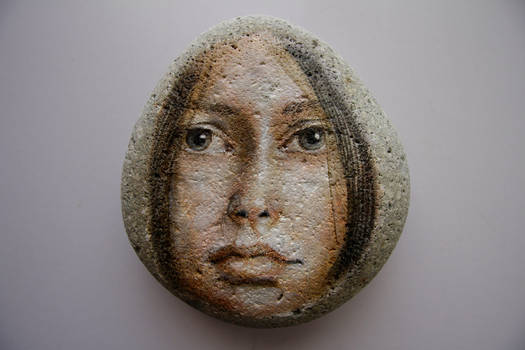 Girl painting on stone