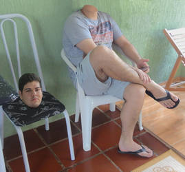 Boy puts his futile head on a next chair