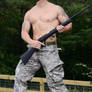 Shirtless soldier with a gun