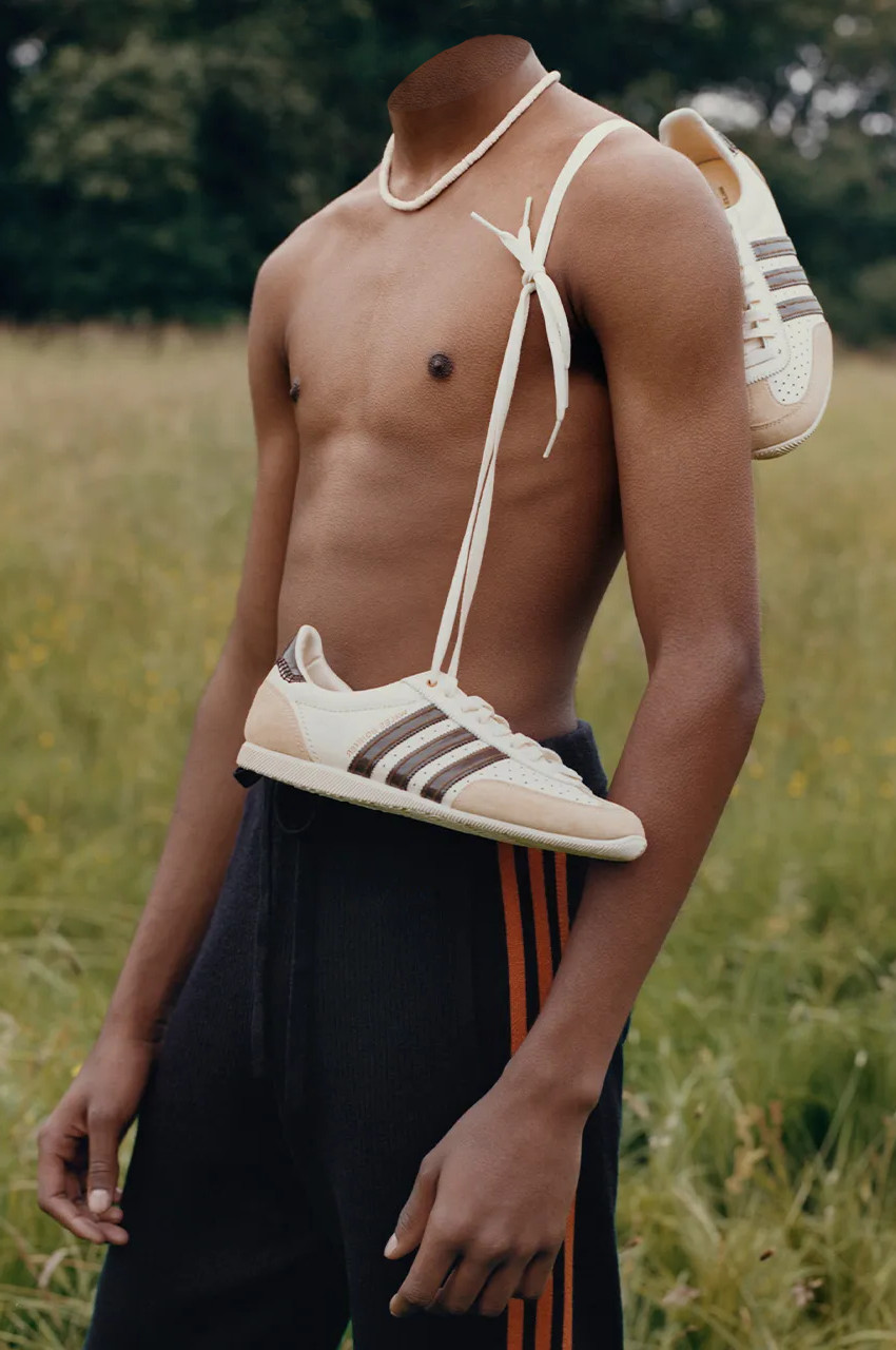 Boy with a sneakers pair hanging over his shoulder