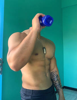 Shirtless soldier drinking water