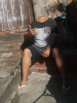 Seated headless man enjoying the day